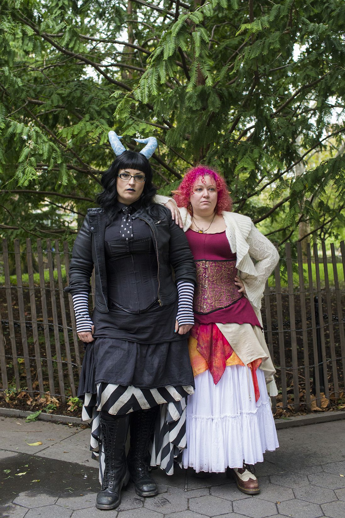 Nami Ouellette and Bruchez and Kristin Brayman, owners of The Fairy Apothecary, pose for a portrait in Washington Square Park during the Pagan Pride Festival on Saturday, October 1, 2016. The Fairy Apothecary creates custom fragrances, lotions and soaps; Brayman said, "People tend to push a gender identity on a fragrance so we are trying to pull that back (for instance) if you’re a guy and want to small like strawberry short cake then go for it, if you’re a girl and you want to smell like tobacco caramel then go for it—we are working with more alternative communities such as people who are agender or transgender and are looking for someone who can find them a fragrance that is not going to push a narrative on to them."<br>